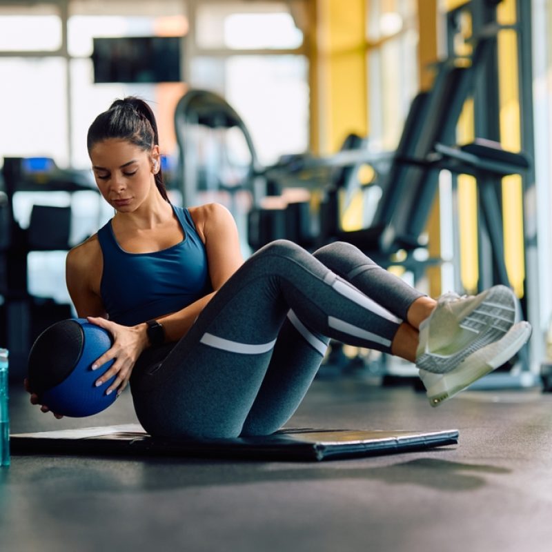 Female,Athlete,Doing,Sit-ups,With,Medicine,Ball,While,Working,Out Female,Athlete,Doing,Sit-ups,With,Medicine,Ball,While,Working,Out